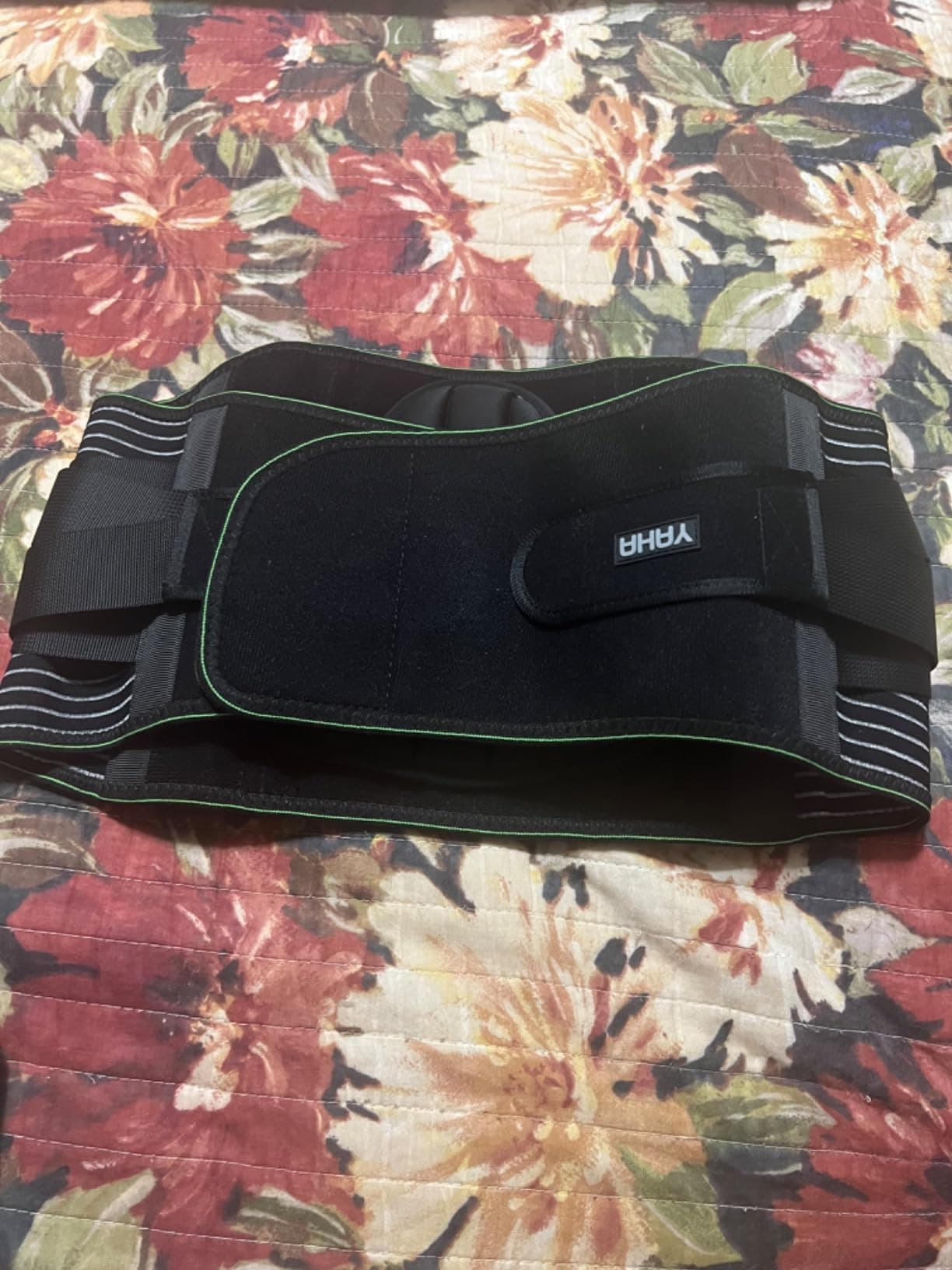 Bracelite back support belt laid flat showing the adjustable side straps